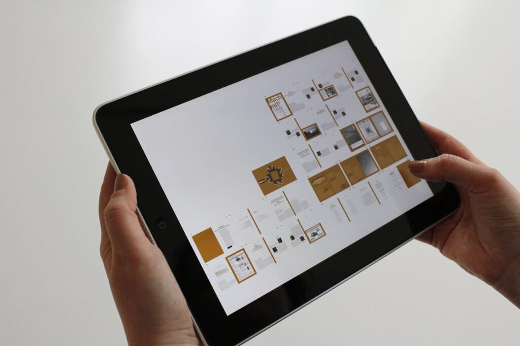 image of hand holding a tablet